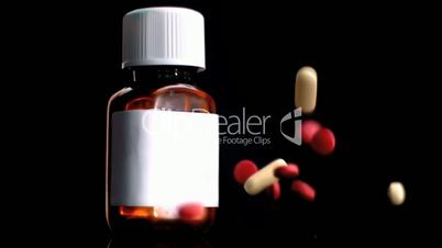 Tablets falling beside medicine jar
