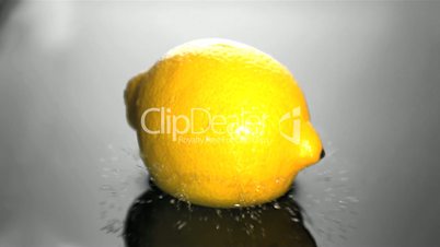 Lemon falling in water close up