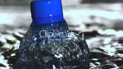 Plastic bottle falling in water