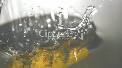 Cob of corn falling in water