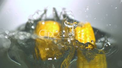 Corn cobs falling in water