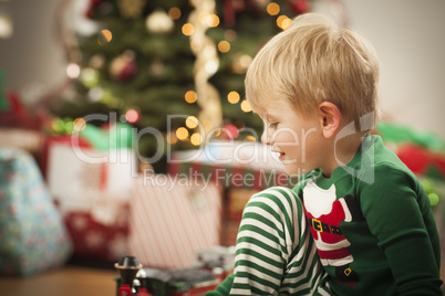 Young Boy Enjoying Christmas Morning Near The Tree