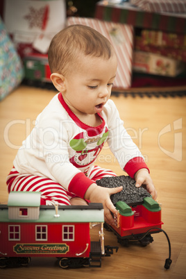 Infant Mixed Race Baby Enjoying Christmas Morning Near The Tree