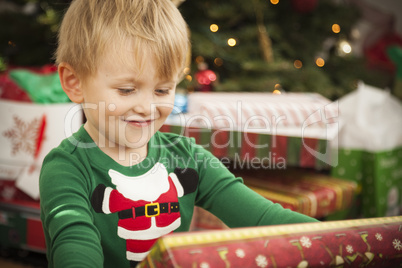 Young Boy Enjoying Christmas Morning Near The Tree