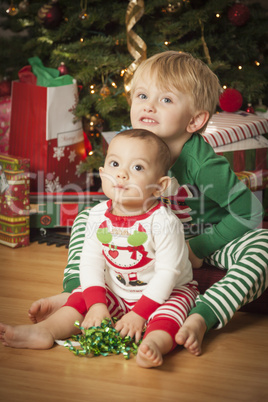 Mixed Race Baby and Young Boy Enjoying Christmas Morning Near Th