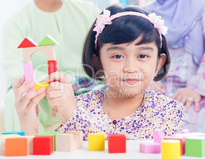 Child building wooden house