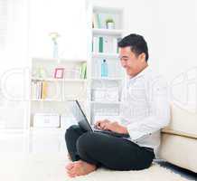 Asian man browsing internet