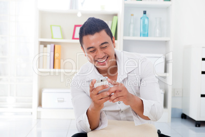 Asian male using smartphone