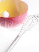 Whisk with bowl and egg
