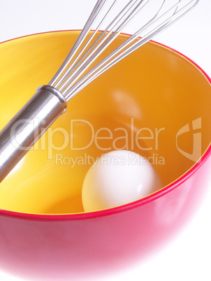 Whisk with bowl and egg