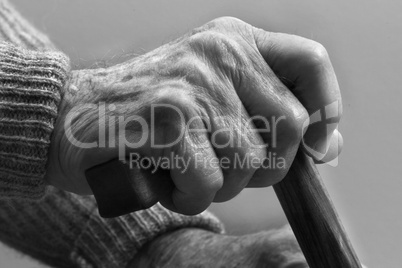 Hand of a senior man with cane