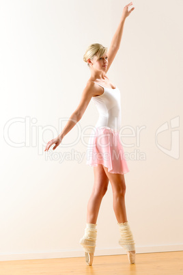 Beautiful ballet dancer practicing dance posture