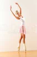 Beautiful ballet dancer practicing dance posture