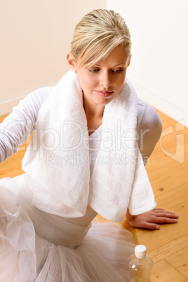 Tired ballerina resting on the studio floor