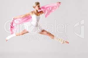 Lovely ballet dancer jumping exercising in studio