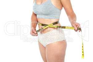 Woman in lingerie's posing with an inch tape