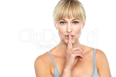 Attractive middle aged woman gesturing silence