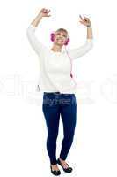 Joyous middle aged woman dancing to the beat