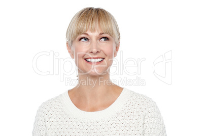 Snap shot of a smiling blonde looking upwards