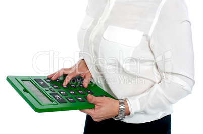 Woman pressing digit 6 on calculator