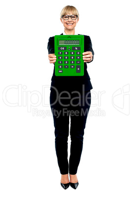 Woman in business suit displaying large green calculator