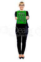 Woman in business suit displaying large green calculator