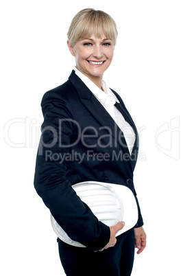 Cheerful female architect holding hardhat