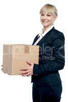Corporate woman with a cardboard box in hand