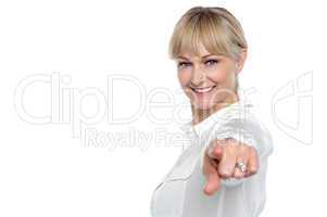 Stylish corporate woman pointing at you