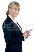 Female executive operating touch screen cellphone