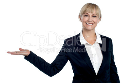 Cheerful business executive presenting copy space area