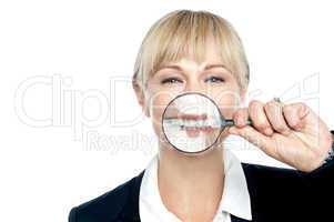 Caucasian woman playing with magnifying glass