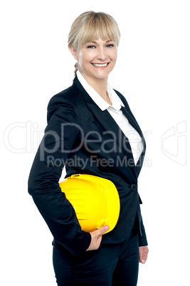 Pretty business architect with yellow safety helmet in hand