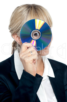 Corporate lady looking through compact disc hole