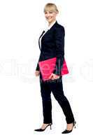Energetic employee walking with her clipboard