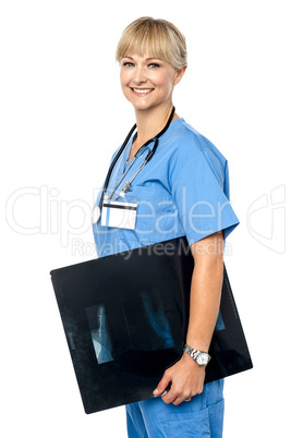 Nurse holding x-ray sheet to be passed up to a senior doctor