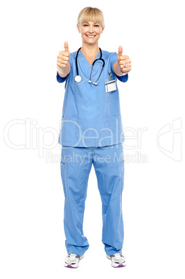 Cheerful lady doctor showing double thumbs up