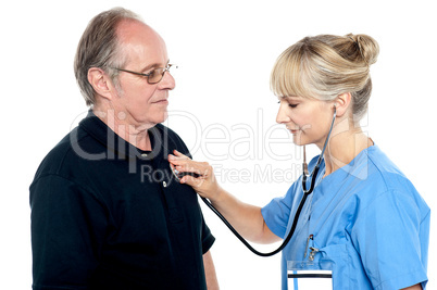 Female doctor examining an elderly man