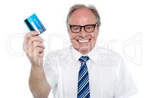 Cheerful aged employer holding up a cash card