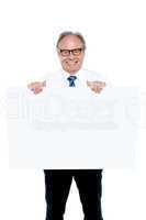 Senior marketing manager holding up a blank ad board