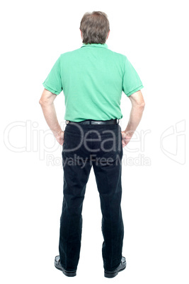 Back pose of a senior man looking at the wall