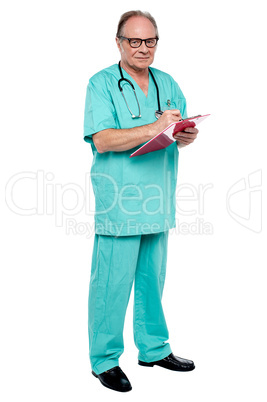 Male doctor in duty hours writing prescription