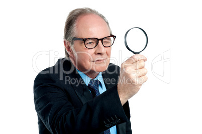 Detective  exploring through a magnifying glass