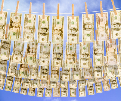 Dollar bills hanging on multiple c