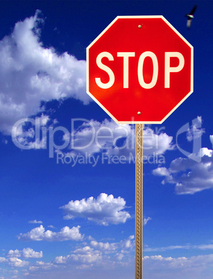 Stop sign on blue cloudy sky