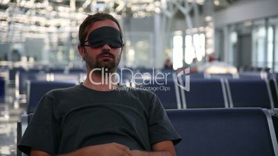 sleeping in airport with eye cover