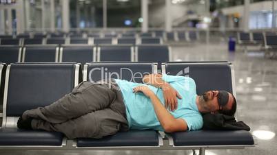 sleeping in airport with eye cover