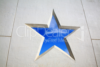 Blue sky through star in white wal