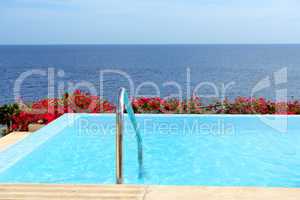 The infinity sea view swimming pool with jacuzzi at luxury hotel