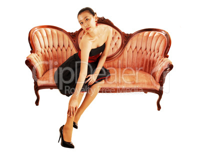 Asian girl sitting on sofa.